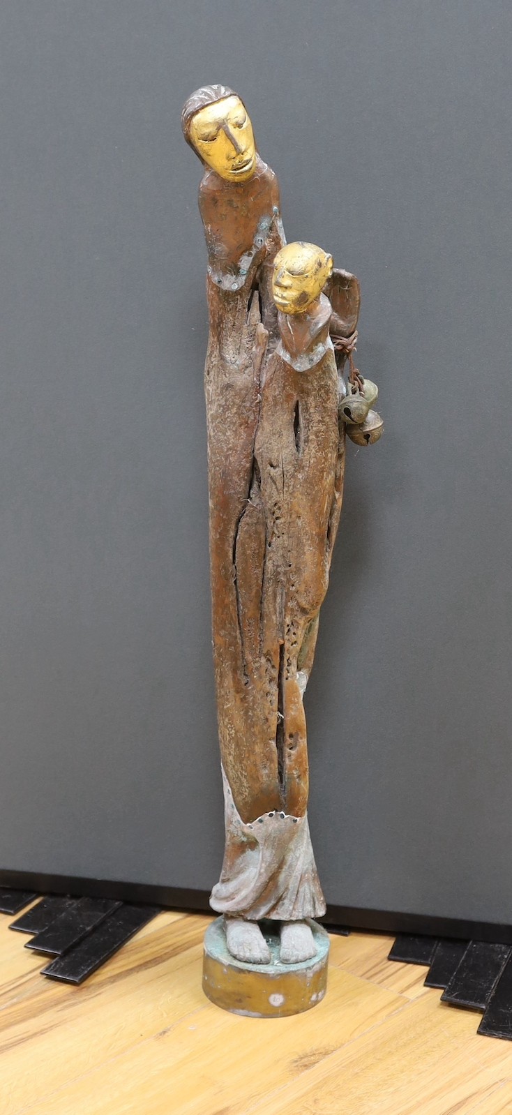 An unusual copper overlaid wooden figural sculpture on bronze base - 96cm tall